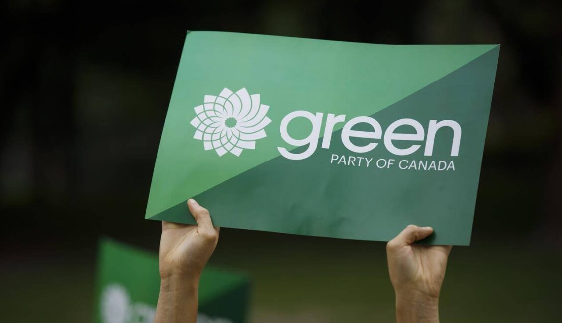 Two hands holding up a Green Party of Canada sign